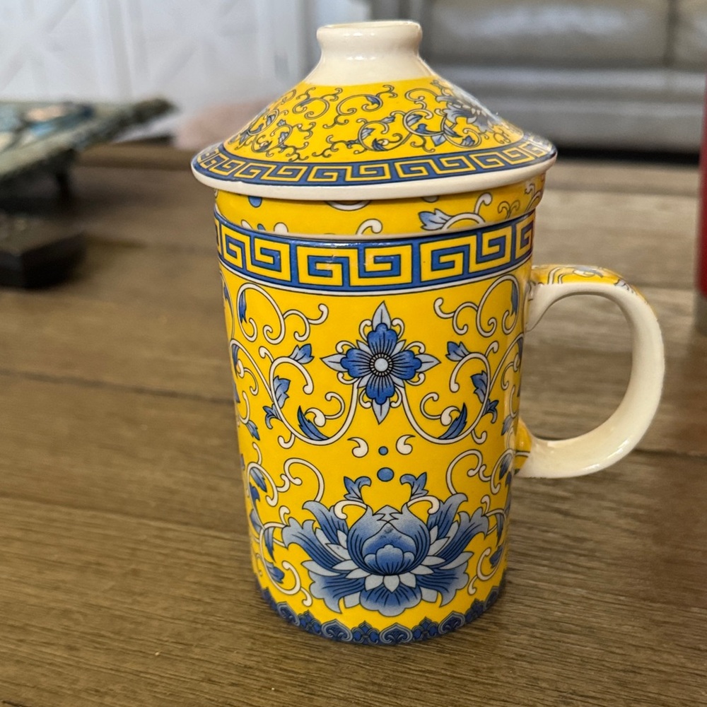 Elegant Yellow and Blue Ceramic Mug with strainer and lid.